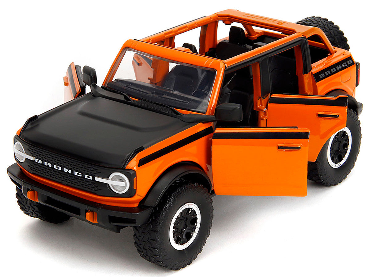 2021 Ford Bronco Open-Top Orange with Black Stripes and Hood with Extra Wheels "Just Trucks" Series 1/24 Diecast Model Car by Jada-1