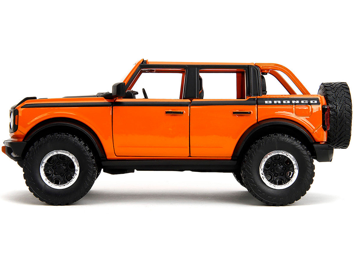 2021 Ford Bronco Open-Top Orange with Black Stripes and Hood with Extra Wheels "Just Trucks" Series 1/24 Diecast Model Car by Jada-0