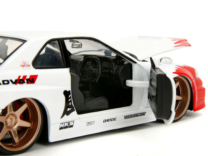 2002 Nissan Skyline GT-R (R34) RHD (Right Hand Drive) White with Red Graphics and Ryu Diecast Figure "Street Fighter" Video Game "Anime Hollywood Rides" Series 1/24 Diecast Model Car by Jada-0