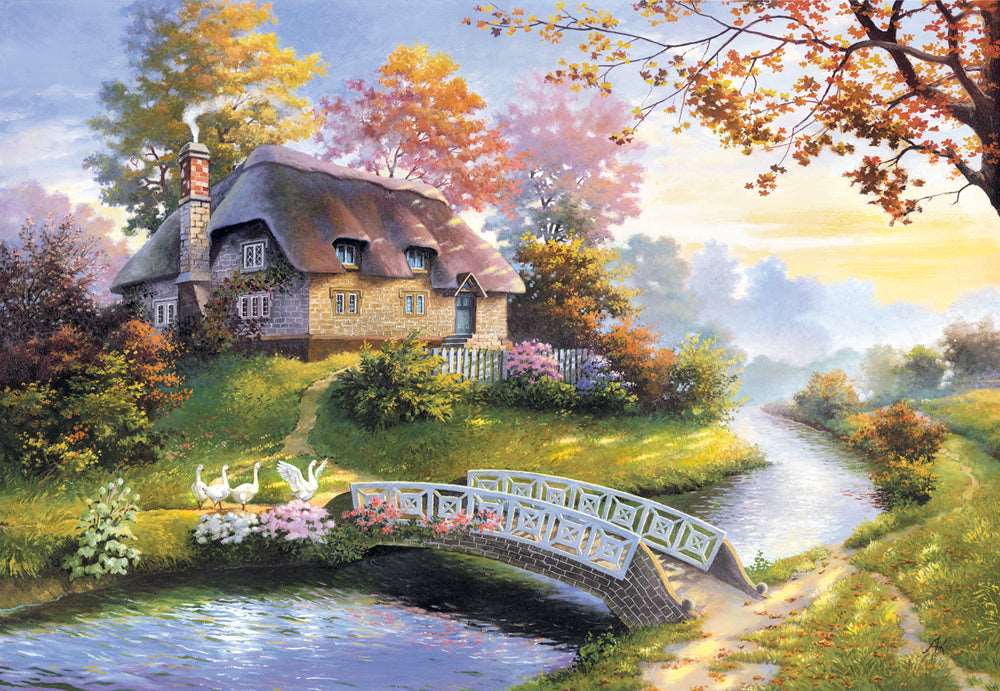 Charming Nook puzzle artwork showing a stone cottage beside peaceful water surrounded by colorful trees