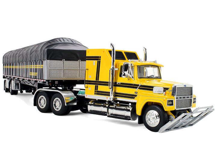 Ford LTL 9000 tractor and Wilson Roadbrute flatbed trailer rear three-quarter view