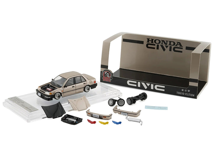 Honda Civic EF2 Champagne Metallic 1/64 diecast model by BM Creations displayed with interchangeable alternate parts and accessories.
