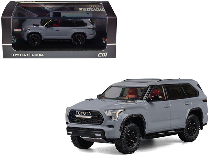 2024 Toyota Sequoia Cement Gray with Red Interior 1/64 diecast model car by CM Models displayed in its original collector packaging.