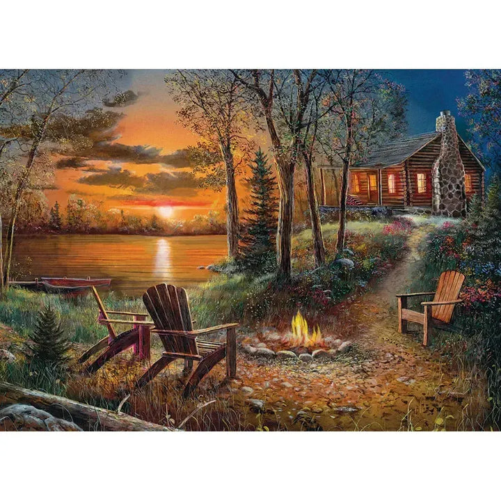 Jack Pine Fireside 1000 Piece Jigsaw Puzzle featuring a cozy lakeside cabin, campfire and colorful sunset wilderness scene - image