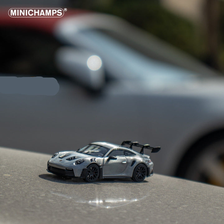 Porsche 911 GT3 RS in Raw Silver English Magazine Version 1:64 by Minichamps (MAGAZINE INCLUDED) Angled Front View Scene