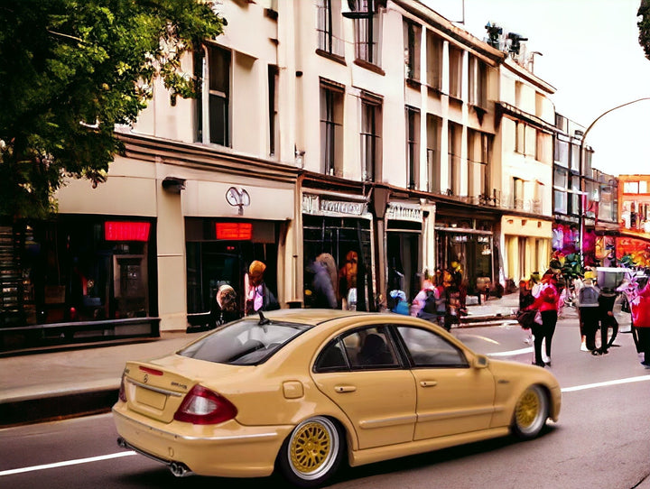 Mercedes-Benz E63 AMG W211 Lowered in Desert Yellow 1:64 by MK Model Angled Rear View Street Scene