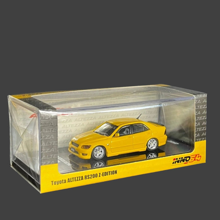 Toyota Altezza RS2000 Yellow With Extra Wheels & Decals 1:64 by Inno64 Package Angle Side View