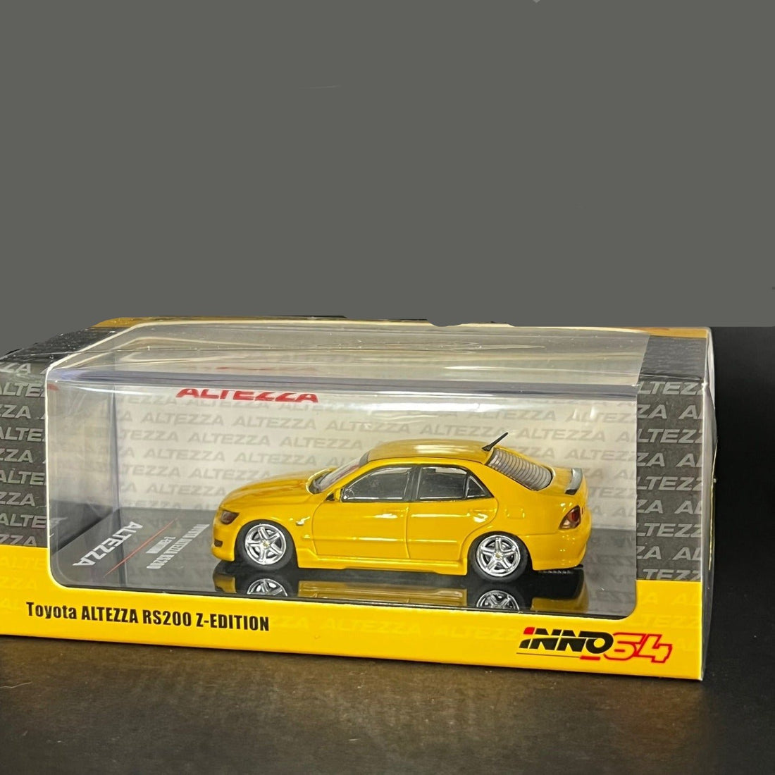 Toyota Altezza RS2000 Yellow With Extra Wheels & Decals 1:64 by Inno64 Package Side View