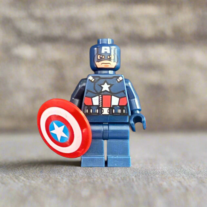 LEGO figure of Captain America holding a shield on a textured surface