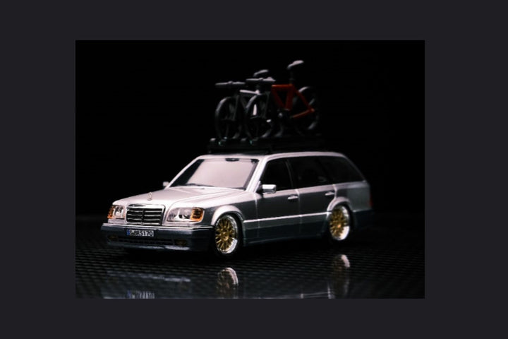 Mercedes-Benz Wagon Version S124 SILVER / BLUE 1:64 by Mortal Angled Front View