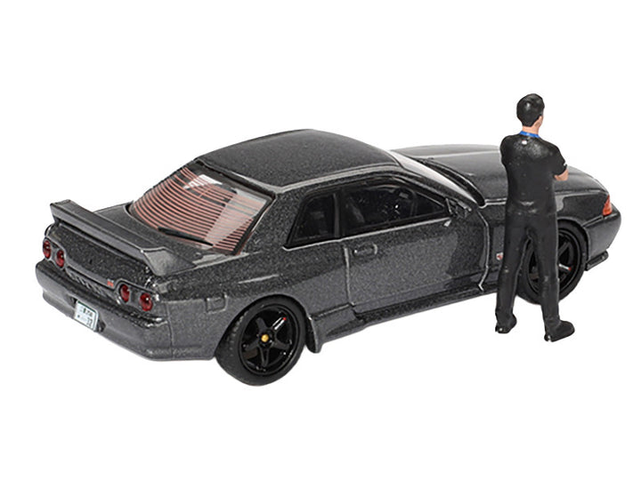 Nissan Skyline GT-R (R32) RHD (Right Hand Drive) Gunmetal Gray Metallic with Tsugio Matsuda Figure Limited Edition 1/64 Diecast Model Car by Mini GT-0