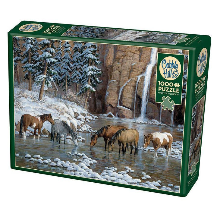 Cobble Hill Spirit of the Rockies 1000 Piece Jigsaw Puzzle featuring horses beside waterfalls in a snowy mountain landscape