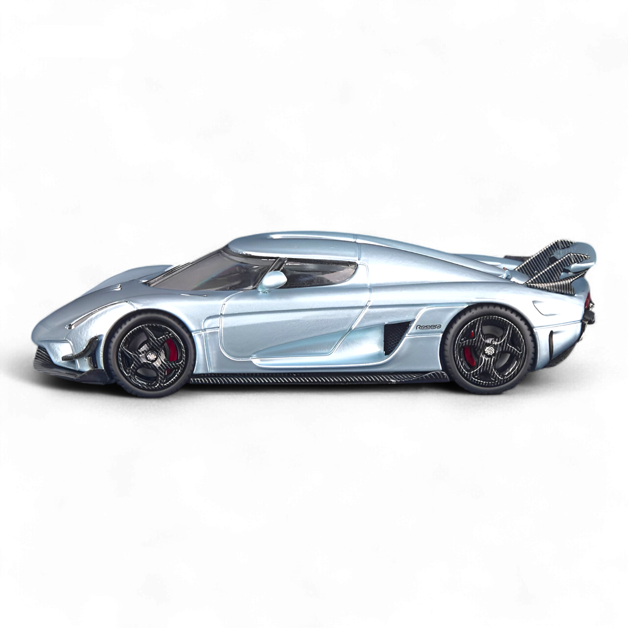 Side view SC ART Koenigsegg Regera Glacier Blue 1:64 diecast model car featuring detailed carbon fiber accents, etched metal parts, and premium collector-quality craftsmanship.