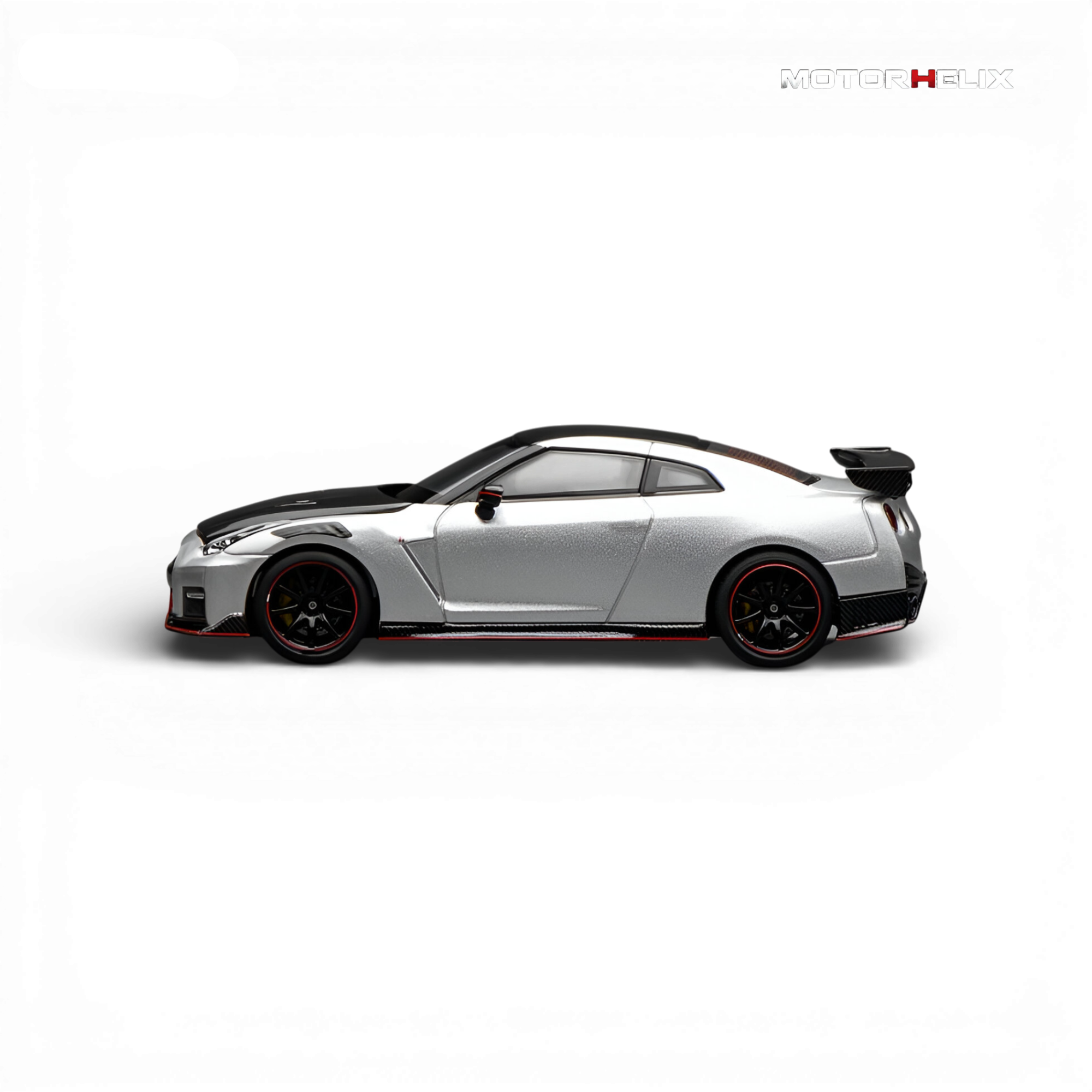 Side profile of the MotorHelix Nissan GT-R NISMO (R35) Special Edition 2022 in Ultimate Metal Silver showcasing the aerodynamic body lines and NISMO styling.