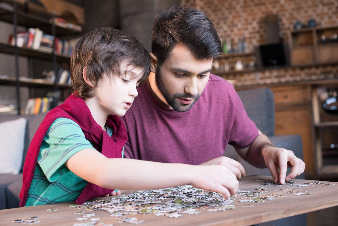 Adult and child assembling a challenging jigsaw puzzle together